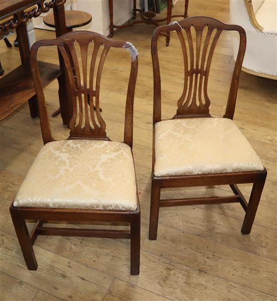 A pair of Georgian Hepplewhite design side chairs
